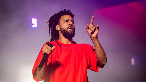 J. Cole performing on stage.